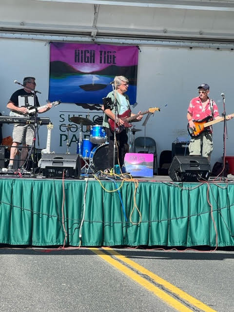 The band High Tide performs on the stage in front of the annual Bellport Firehouse craft fair. 